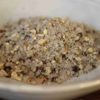 Mélange aromatique de poivre noir et d'écorces séchées dans un bol blanc.