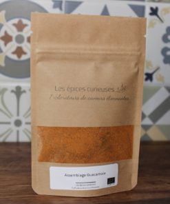 Mélange d'épices Assemblage Guacamole par Les Épices Curieuses, sur fond de carrelage coloré.