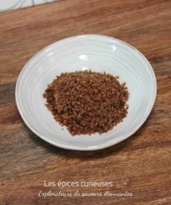 Bol de sucre brun sur une table en bois.