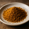 Assiette de poudre d'épices dorée, prête à ajouter saveur et couleur aux plats.