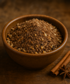 Bol de granola épicé avec bâtons de cannelle et badiane sur fond en bois. Idéal pour un petit déjeuner savoureux.